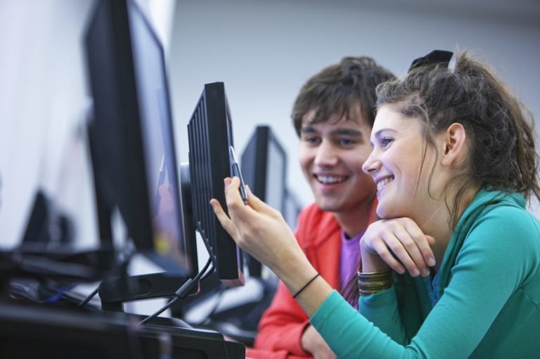 Side,View,Of,Two,Young,University,Students,Using,Computers