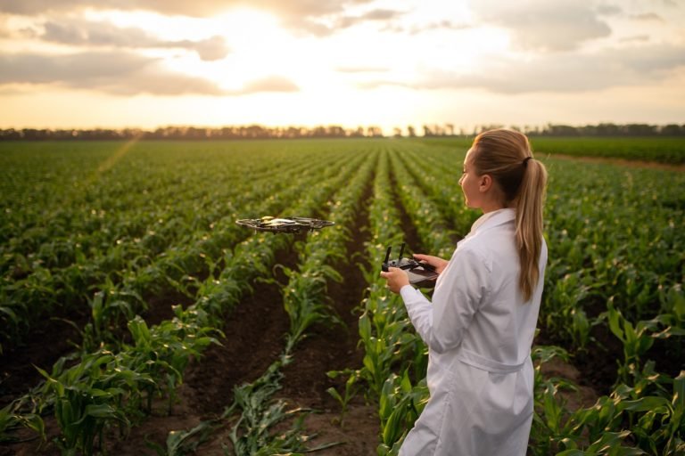 Female,Agricultural,Specialist,Holding,Drone,Remote,And,Controlling,Drone,In