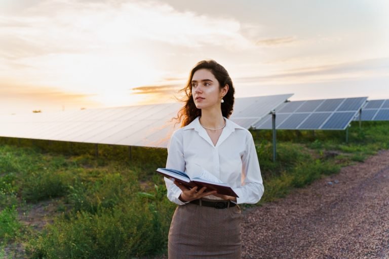 Investor,Woman,Stand,And,Read,Book,Near,Solar,Panels,Row