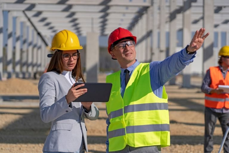 Businessman,And,Young,Female,Architect,With,Digital,Tablet,Meeting,At