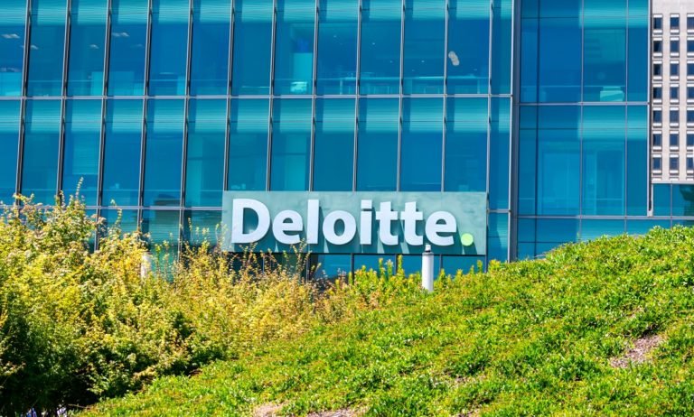 Deloitte,Logo,Is,Seen,Above,Green,Landscaping,On,Company,Office