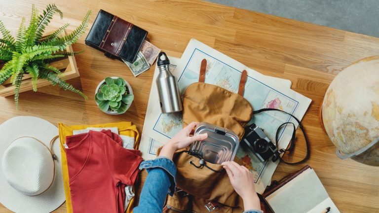 Top,View,Of,Young,Woman,Packing,For,Vacation,Trip,Holiday,
