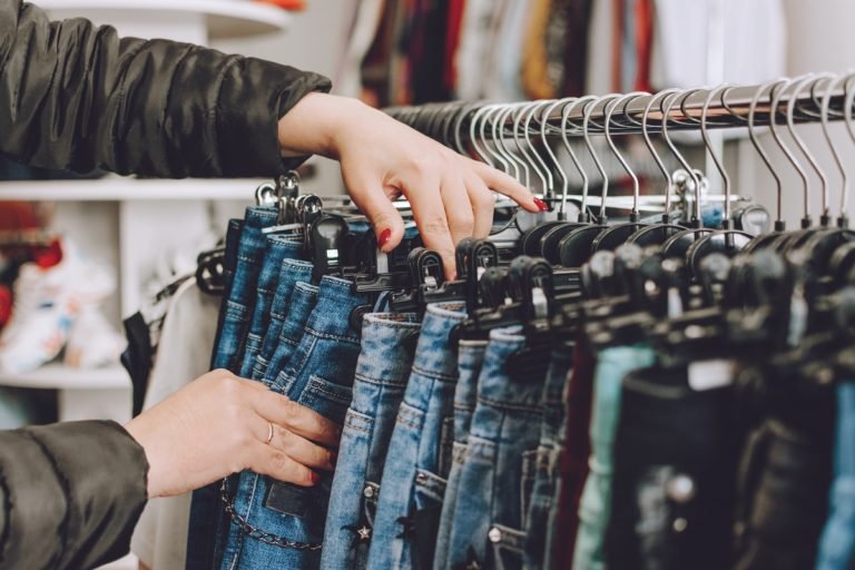 Fast,Fashion,Concept.,Woman,Chooses,Jeans,In,A,Store