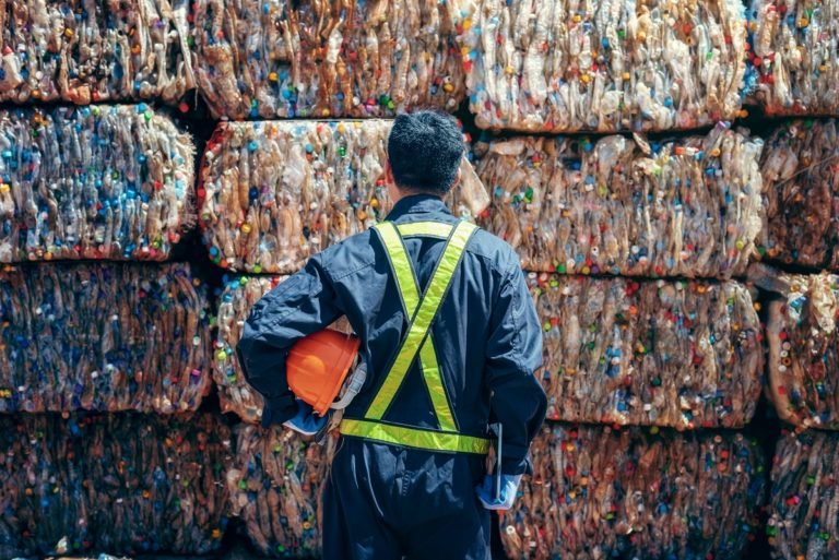Engineer,Standing,And,Looking,Back,The,Plastic,Bottle,In,The